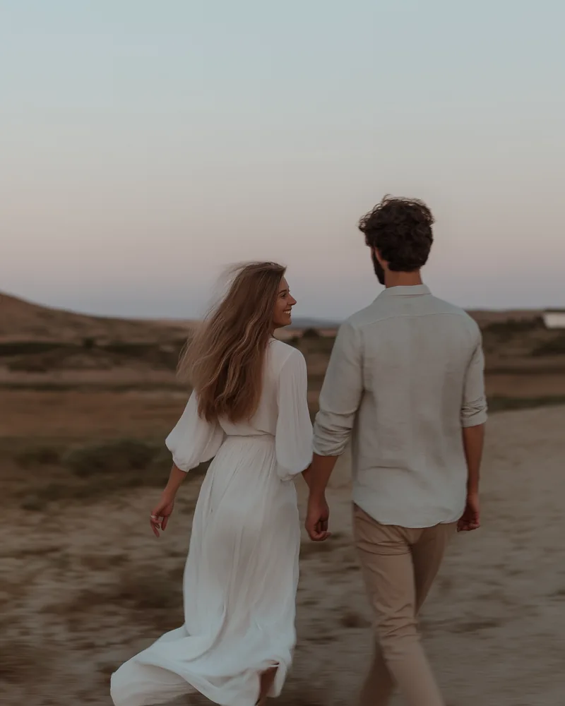 Couple walking hand in hand during a destination wedding in Cyprus at sunset